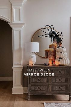 halloween decorations on top of a dresser in a living room