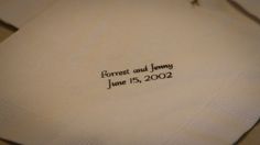 two folded napkins with the words forrest and jenny printed on them, sitting next to each other