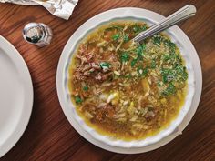 a bowl of soup on a wooden table