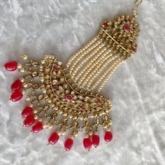 Faux Champagne Kundan side jhumar in antique gold polish with ruby bead detailing.  Hook at the end of the jhumar makes it easy to attach this beauty to any hair do! Ready to ship with gift packaging as standard Gold Kundan Tikka For Rituals, Heavy Tikka For Festive Rituals, Traditional Gold Dupatta With Stone Work, Red Tikka With Latkans For Festive Occasions, Heavy Festive Tikka For Rituals, Heavy Tikka For Rituals And Festive Occasions, Festive Red Tikka With Tilla Details, Red Tikka For Eid Festive Occasion, Red Tikka For Eid Festival