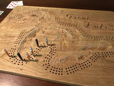 a wooden board that has some screws in it and the words great lakes on it