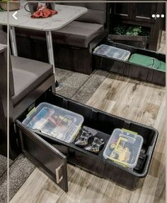 an open storage compartment in the middle of a living room next to a dining table