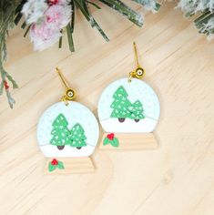 pair of christmas tree earrings on wooden surface