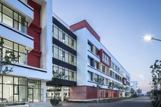 an apartment building with red and white accents