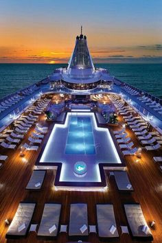 the sun sets over an outdoor swimming pool on a cruise ship