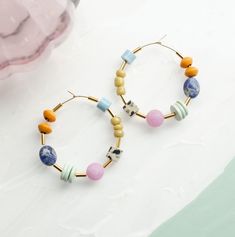 ---------------- PLEASE READ DESCRIPTION BEFORE ORDERING ------------- Set of bright and colorful beaded hoop earrings DETAILS: 40mm hoops Gold filled hoops Earring post are lead and nickel free. PROCESSING TIME: Our items are made to order. Processing times may vary due to holidays or demand. The processing time for this item is 1-3 business days before it ships. In order to ship each order on time, we are not able to bypass the processing times on any of our items. If you are under time restra Multicolor Small Hoop Jewelry With Spacer Beads, Trendy Colorful Hoop Jewelry, Colorful Bohemian Hoop Jewelry, Everyday Multicolor Jewelry, Multicolor Hoop Jewelry With Spacer Beads, Colorful Beaded Round Hoop Earrings, Multicolor Beaded Hoop Jewelry, Multicolor Hoop Beaded Earrings With Spacer Beads, Multicolor Beaded Hoop Earrings With Spacer Beads