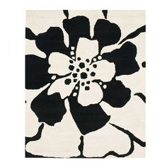 a black and white rug with flowers on it