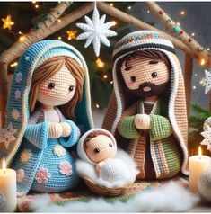 two crocheted nativity dolls with a baby jesus in front of a christmas tree