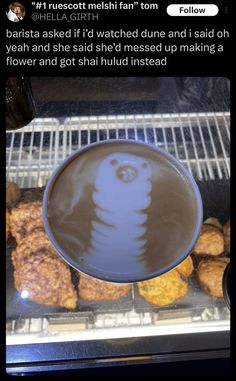 a bowl filled with food sitting on top of a metal rack next to other foods