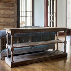 a wooden bench sitting on top of a hard wood floor