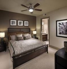 a bedroom with a large bed and pictures on the wall