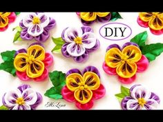 paper flowers are arranged in different colors and sizes on a white background with the words diy written below them