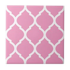 a pink and white tile with an intricate design