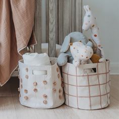 two storage baskets with stuffed animals in them