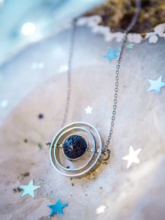 If you like astronomy, galaxies and outer space, this spinning necklace is the perfect accessory for you. This beautiful piece is made with 3 silver-plated brass rings, elegantly placed one inside the other to create a pendant inspired by the planetary galactic orbits. The inner piece is Natural Lava Stone Bead and imitates the texture and shape of an asteroid. ✦ You can spin the necklace! It's truly satisfying and entertaining to spin while you're wearing it! It's almost anti-stress! Such a del Nickel-free Adjustable Space-themed Jewelry, Celestial Style Round Metal Pendant Jewelry, Celestial Satellite Chain Jewelry As Gift, Celestial Jewelry With Satellite Chain For Gifts, Celestial Jewelry With Satellite Chain As A Gift, Celestial Style Jewelry With Satellite Chain As Gift, Celestial Stainless Steel Jewelry With Moon Phase, Silver Space-themed Jewelry Gift, Celestial Stainless Steel Moon Phase Jewelry