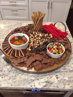 a platter filled with chocolate, candy and crackers