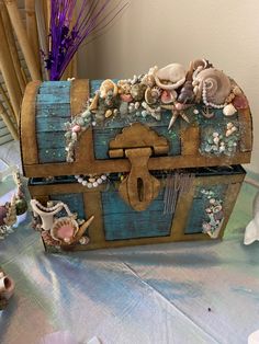 an old trunk is decorated with shells and seashells