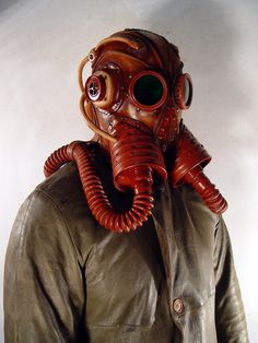 a man wearing a gas mask and leather jacket