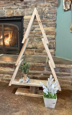 a fireplace with a potted plant in front of it