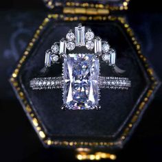 an engagement ring with a cushion cut diamond surrounded by round and baguette diamonds