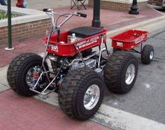 a red four wheeled vehicle parked on the street