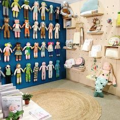 there are many dolls hanging on the wall in this room, and one is holding hands with another doll