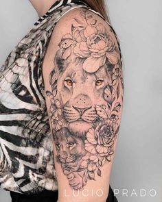 a woman with a lion and flowers tattoo on her arm