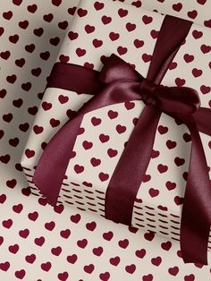 two wrapped gift boxes with hearts on them