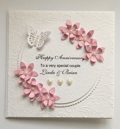 a white card with pink flowers and butterflies on it