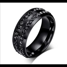 black wedding ring with white diamonds on it