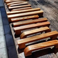 a row of wooden benches sitting on top of a sidewalk