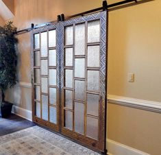 a living room with sliding glass doors and potted plant