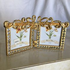 two gold framed pictures with flowers on them