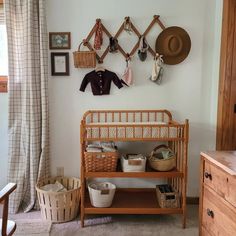 a baby's crib in the corner of a room next to a dresser