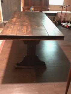 a wooden table sitting in the middle of a room