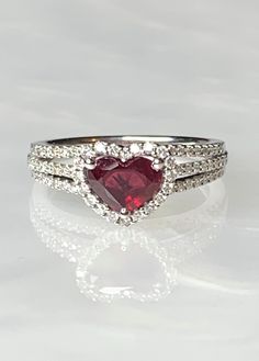 Heart Shaped Ruby Ring, Ruby Ring, Ruby Engagement Ring, Heart Ruby Ring, Ruby Ring For Women, Heart Ring, Heart Ring For Women, Luxury Gift This brand new 18k white gold ring is the ultimate symbol of love, featuring a high quality deep red heart shaped ruby weighing 1.15 carats surrounded by 0.43 carats of sparkling genuine white diamonds forming a perfect halo around the center stone and along the 3 row diamond encrusted band. *Approximate ring weight: 4.69 grams * Please note: This ring is p Kay Jewelers Engagement Rings, Dainty Earrings Studs, Engagement Ring Heart, Antique Emerald Ring, Vintage Sapphire Ring, Emerald Ring Vintage, Red Stone Ring, Ring Ruby, Heart Engagement Rings