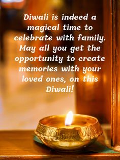 a golden candle sitting on top of a table next to a wooden frame with a quote about diwali