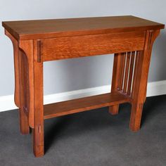 a wooden table sitting on top of a carpeted floor