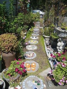 an outdoor garden with stepping stones and potted plants