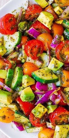 Tomato Cucumber Avocado Salad with Basil Pesto on a white plate Basil Recipes Salad, Salads With Avocado Recipes, April Recipes Healthy, Cooked Vegetable Salad, Healthy Recipes Vegetables, Vegetable Salad Recipes Healthy, Vegetables Salad Recipes, Pesto Vegetables, Spring Vegetable Salad