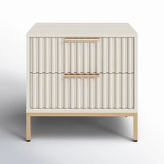 an image of a white cabinet with gold trimmings on the doors and drawers