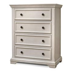 a white dresser with four drawers on it