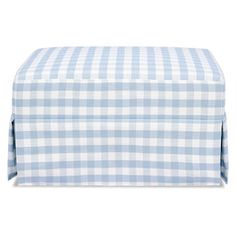 the blue and white gingham checkered bed skirt is folded on top of it