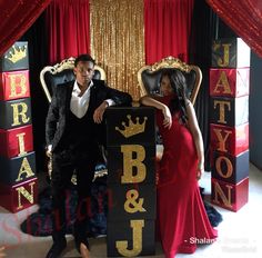 a man and woman posing for a photo in front of a sign that says bb & j