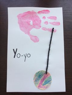 a piece of paper that says yo - yo with a hand print on it and a black string