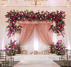 a wedding ceremony setup with pink and white flowers