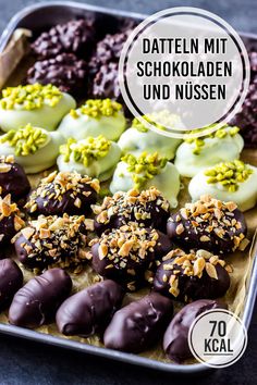 an assortment of chocolates in a metal tray with the words daten mit schokoladen und nussen