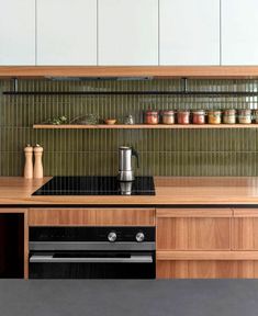 a kitchen with an oven, stove and cabinets on the counter top in front of it