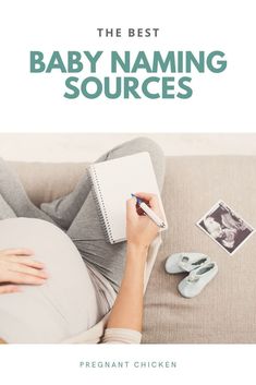 a pregnant woman is writing on her notebook while holding a pen and sitting on the couch