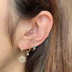 a close up of a person's ear with two different types of piercings